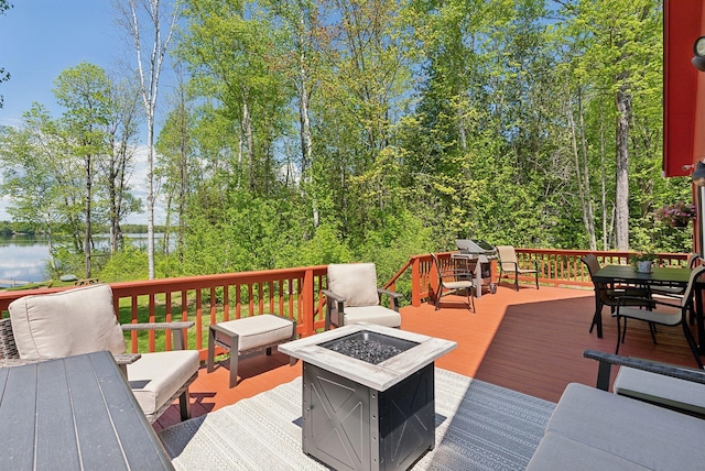 80 Hart St, Newport, ME 04953 - wooden terrace featuring a fire pit, outdoor dining area, and a water view