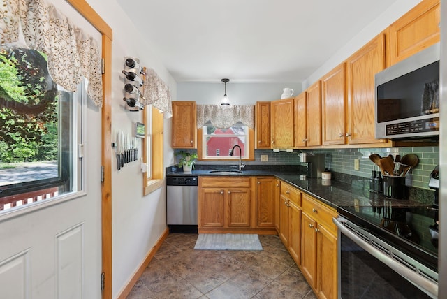 80 Hart St, Newport, ME 04953 - kitchen featuring appliances with stainless steel finishes, a sink, decorative backsplash, tile patterned flooring, and brown cabinets