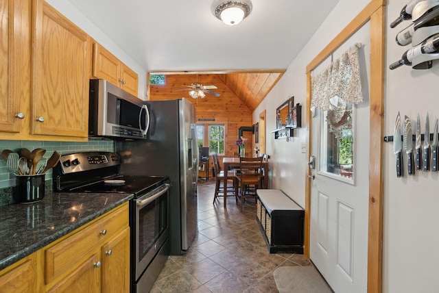 80 Hart St, Newport, ME 04953 - kitchen featuring stainless steel appliances, wood walls, lofted ceiling, a ceiling fan, and decorative backsplash