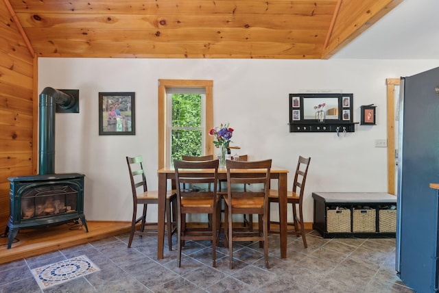 80 Hart St, Newport, ME 04953 - tiled dining room featuring wooden ceiling, vaulted ceiling, and a wood stove