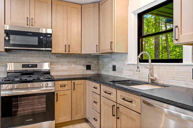 734 Main Rd, Charleston, ME 04422 - kitchen featuring stainless steel appliances, dark stone countertops, decorative backsplash, and light brown cabinetry