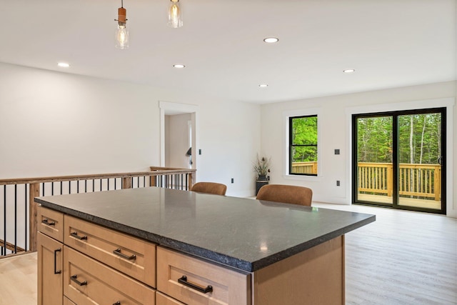 734 Main Rd, Charleston, ME 04422 - kitchen featuring light wood-type flooring, open floor plan, recessed lighting, a center island, and decorative light fixtures