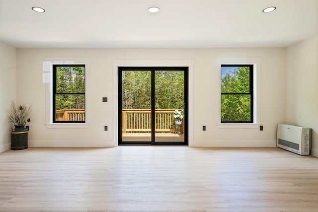 734 Main Rd, Charleston, ME 04422 - spare room featuring heating unit, light wood finished floors, and recessed lighting