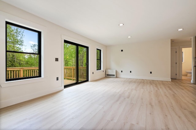 734 Main Rd, Charleston, ME 04422 - empty room featuring healthy amount of natural light, light wood-style flooring, heating unit, and recessed lighting