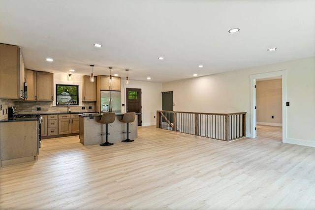 734 Main Rd, Charleston, ME 04422 - kitchen with stainless steel appliances, a kitchen island, light wood-type flooring, and recessed lighting