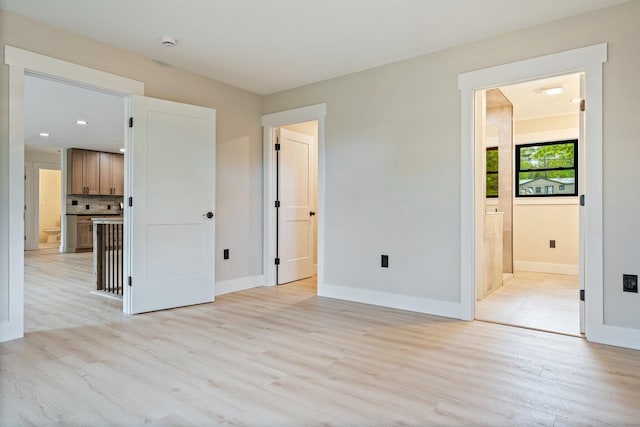 734 Main Rd, Charleston, ME 04422 - unfurnished bedroom with light wood finished floors, ensuite bathroom, and recessed lighting