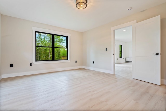 734 Main Rd, Charleston, ME 04422 - unfurnished room featuring plenty of natural light, light wood finished floors, and a smoke detector