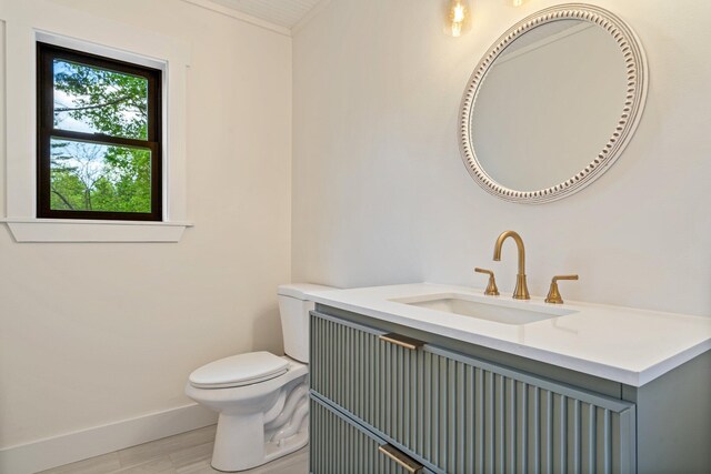 734 Main Rd, Charleston, ME 04422 - half bathroom featuring wood finished floors and vanity
