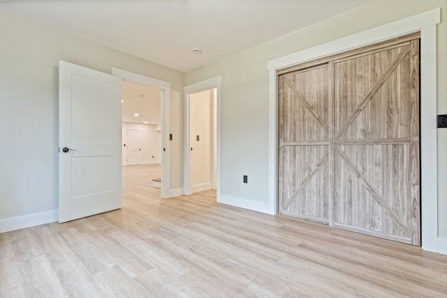 734 Main Rd, Charleston, ME 04422 - unfurnished bedroom featuring wood finished floors and baseboards