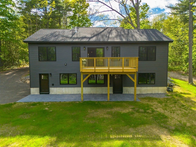 734 Main Rd, Charleston, ME 04422 - back of house featuring a yard, a patio, and a shingled roof
