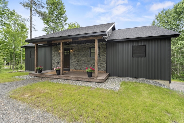 734 Main Rd, Charleston, ME 04422 - view of front of property with roof with shingles, covered porch, stone siding, and a front yard