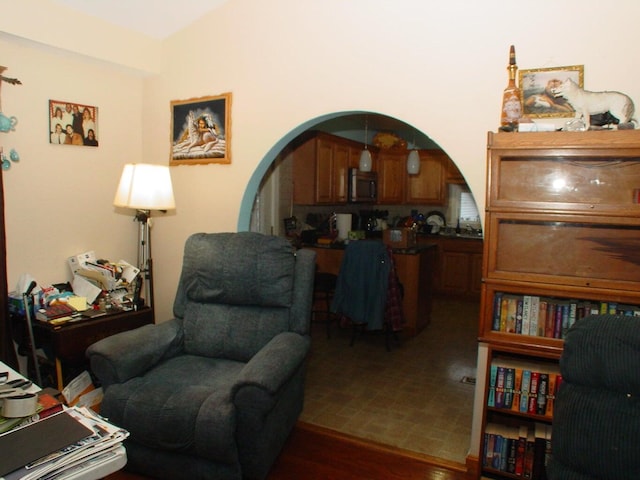 348-350 Lakeview Rd, Glenburn, ME 04401 - sitting room with arched walkways and wood finished floors