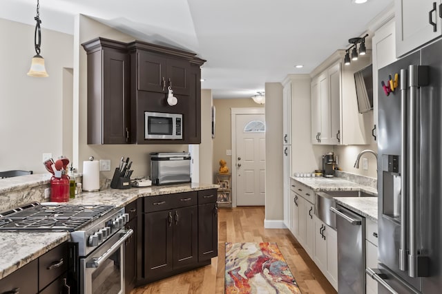 8 Macintosh Ln, Lewiston, ME 04240 - kitchen featuring stainless steel appliances, light wood-style flooring, recessed lighting, light stone countertops, and decorative light fixtures