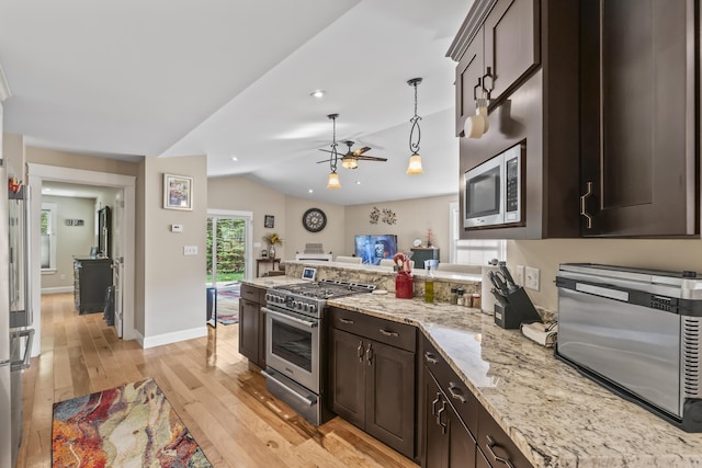 8 Macintosh Ln, Lewiston, ME 04240 - kitchen with stainless steel appliances, a peninsula, light wood-type flooring, dark brown cabinetry, and vaulted ceiling