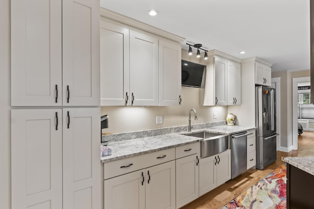 8 Macintosh Ln, Lewiston, ME 04240 - kitchen with stainless steel appliances, a sink, light wood-style flooring, light stone countertops, and recessed lighting