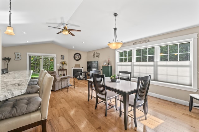 8 Macintosh Ln, Lewiston, ME 04240 - dining space with vaulted ceiling, light wood finished floors, a glass covered fireplace, ceiling fan, and recessed lighting