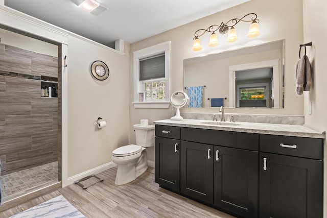 8 Macintosh Ln, Lewiston, ME 04240 - bathroom with baseboards, vanity, tiled shower, and toilet