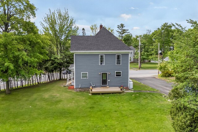 727 Hammond St, Bangor, ME 04401 - rear view of house featuring a deck, a lawn, a chimney, and roof with shingles