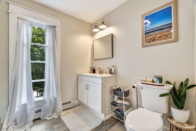 727 Hammond St, Bangor, ME 04401 - bathroom featuring vanity, toilet, and baseboard heating