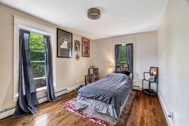 727 Hammond St, Bangor, ME 04401 - bedroom with baseboard heating, multiple windows, hardwood / wood-style flooring, and baseboards