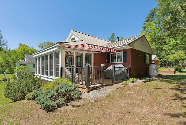 193 Park Ln, Windsor, ME 04363 - view of front of home with a deck, a sunroom, a standing seam roof, and metal roof