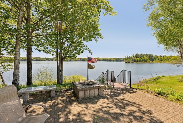 193 Park Ln, Windsor, ME 04363 - view of patio / terrace with a water view and an outdoor fire pit