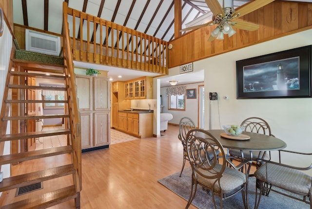 193 Park Ln, Windsor, ME 04363 - dining area with high vaulted ceiling, light wood finished floors, ceiling fan, and stairs