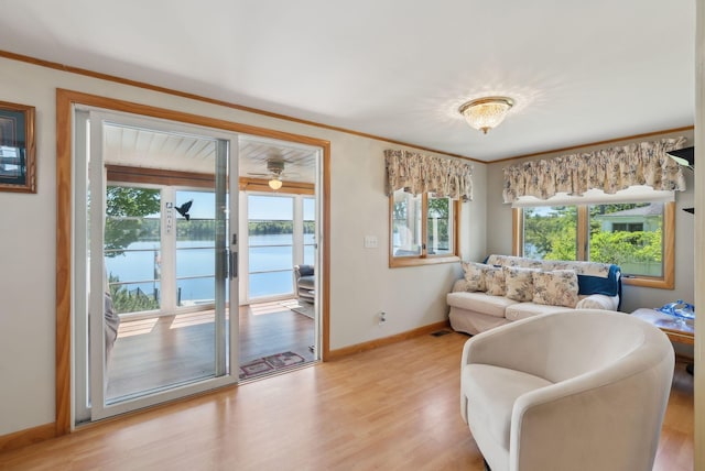 193 Park Ln, Windsor, ME 04363 - living room featuring healthy amount of natural light, light wood-style floors, a water view, baseboards, and ornamental molding