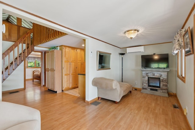 193 Park Ln, Windsor, ME 04363 - living room with a wall mounted air conditioner, light wood-type flooring, baseboards, and stairway