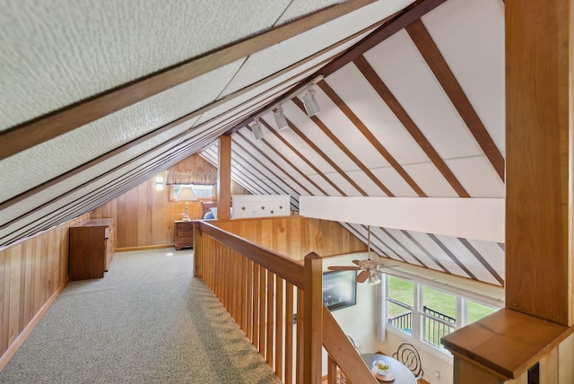 193 Park Ln, Windsor, ME 04363 - corridor featuring vaulted ceiling, wooden walls, an upstairs landing, and carpet flooring
