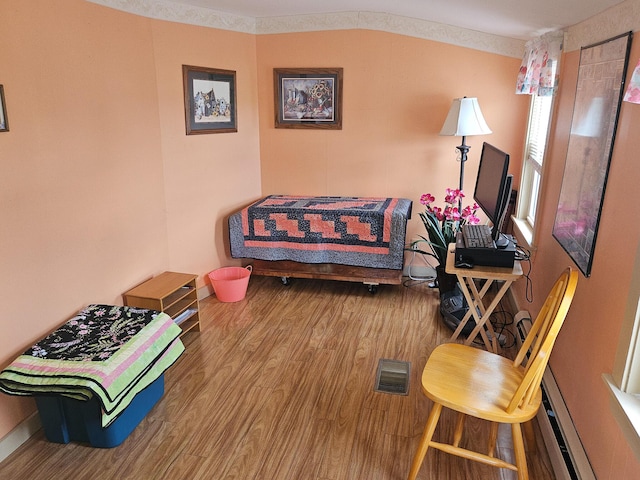 856 Weeks Mills Rd, New Sharon, ME 04955 - living room with wood finished floors, baseboards, and a baseboard radiator