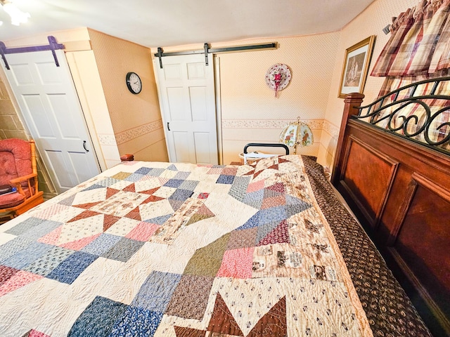 856 Weeks Mills Rd, New Sharon, ME 04955 - bedroom featuring a barn door and wallpapered walls