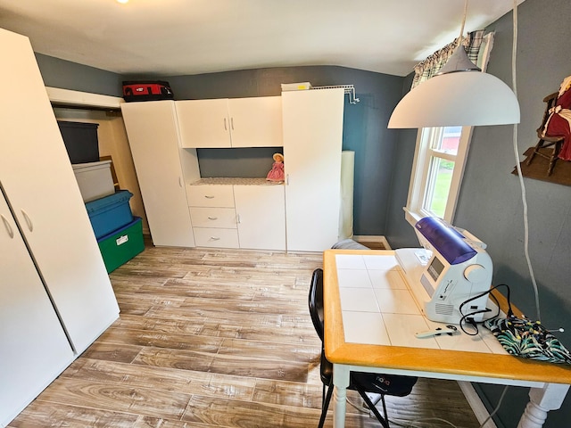 856 Weeks Mills Rd, New Sharon, ME 04955 - home office featuring light wood-type flooring and vaulted ceiling