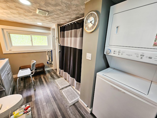 856 Weeks Mills Rd, New Sharon, ME 04955 - laundry room with estacked washer and dryer, dark wood-type flooring, baseboards, and recessed lighting