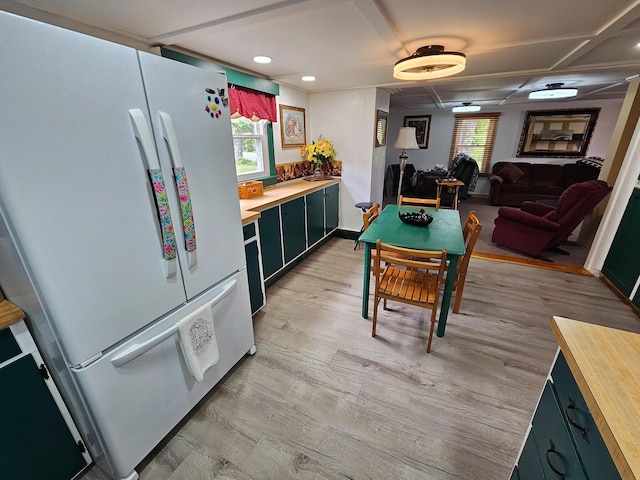 856 Weeks Mills Rd, New Sharon, ME 04955 - kitchen with freestanding refrigerator, butcher block countertops, light wood-type flooring, recessed lighting, and green cabinetry