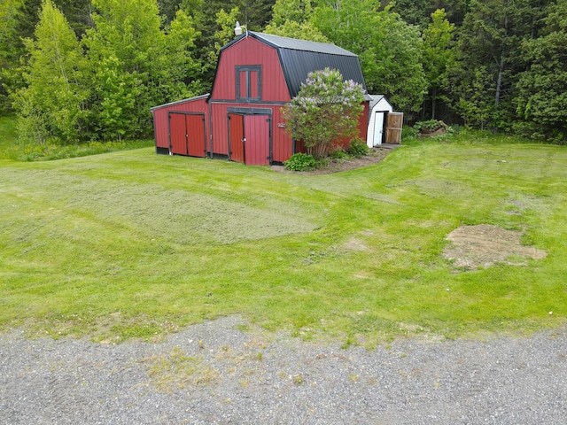 856 Weeks Mills Rd, New Sharon, ME 04955 - view of grassy yard featuring an outdoor structure, a barn, a view of trees, and a garage