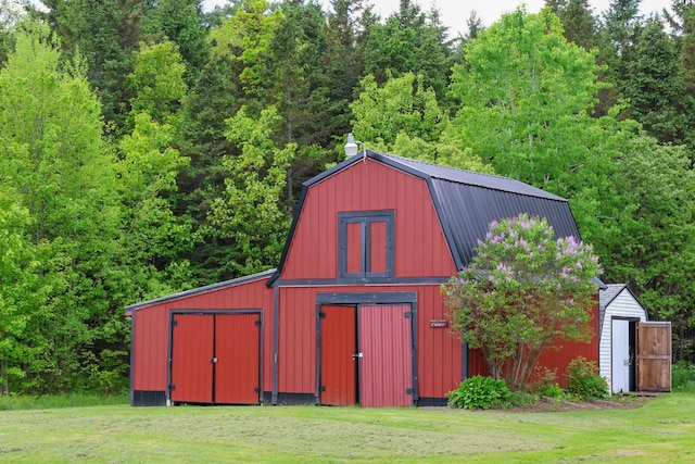 856 Weeks Mills Rd, New Sharon, ME 04955 - view of barn with a yard and a view of trees