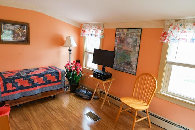 856 Weeks Mills Rd, New Sharon, ME 04955 - bedroom featuring multiple windows, wood finished floors, and baseboard heating