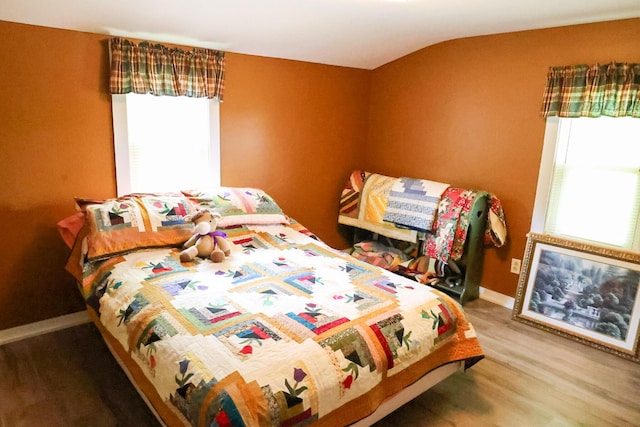 856 Weeks Mills Rd, New Sharon, ME 04955 - bedroom with multiple windows, wood finished floors, and baseboards