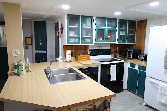 856 Weeks Mills Rd, New Sharon, ME 04955 - kitchen featuring freestanding refrigerator, range with electric stovetop, stainless steel microwave, a sink, and a peninsula