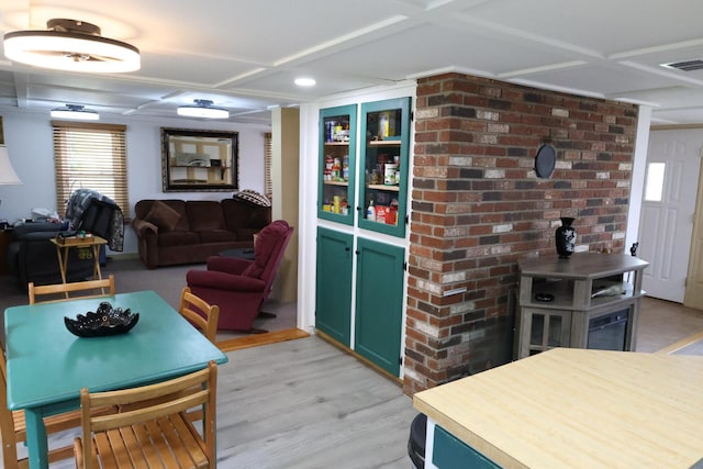 856 Weeks Mills Rd, New Sharon, ME 04955 - living area featuring light wood-style floors, coffered ceiling, a wood stove, and recessed lighting