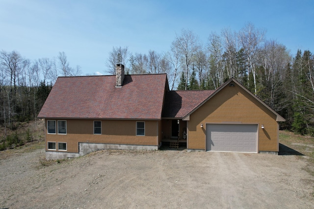 12 Jl Dr, Eustis, ME 04936 - rustic home featuring driveway, a chimney, and an attached garage