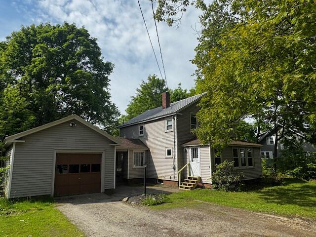 19 Prospect St, Skowhegan, ME 04976 - view of front of house featuring an attached garage, entry steps, asphalt driveway, and a chimney