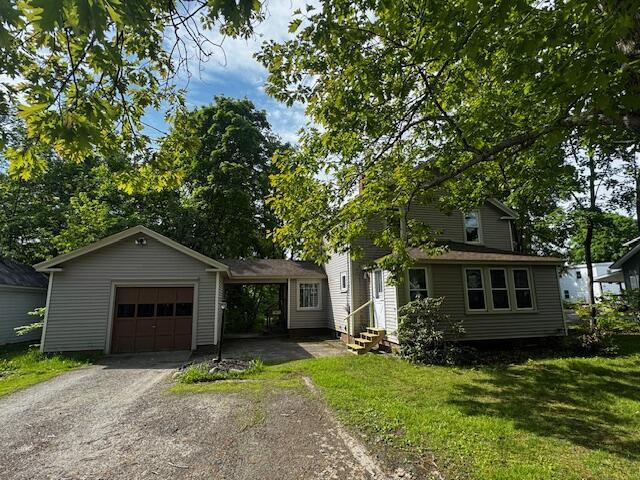 19 Prospect St, Skowhegan, ME 04976 - view of front facade with entry steps, a front yard, driveway, and an attached garage
