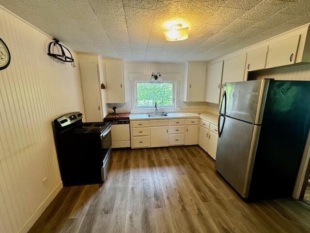 19 Prospect St, Skowhegan, ME 04976 - kitchen featuring stainless steel appliances, dark wood finished floors, a sink, and white cabinetry