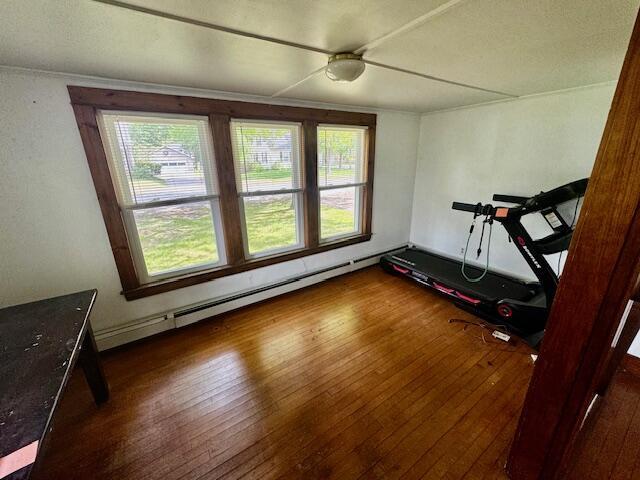 19 Prospect St, Skowhegan, ME 04976 - exercise room featuring hardwood / wood-style floors, a baseboard heating unit, and a ceiling fan