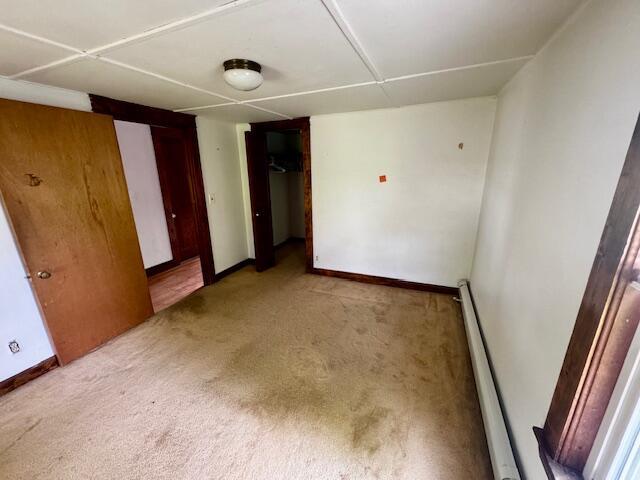 19 Prospect St, Skowhegan, ME 04976 - unfurnished bedroom with light carpet, a baseboard radiator, and baseboards