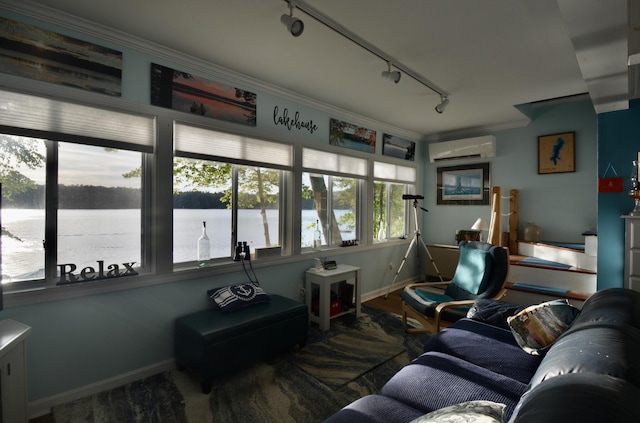 12B Trues Point Rd, New Gloucester, ME 04260 - living room with a wall unit AC, track lighting, a water view, crown molding, and baseboards