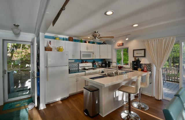 12B Trues Point Rd, New Gloucester, ME 04260 - kitchen featuring white appliances, white cabinetry, a peninsula, dark wood-style flooring, and ornamental molding