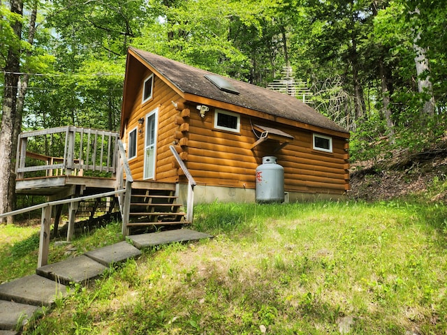 75 Snow Goose Ln, Dexter, ME 04930 - view of side of home featuring log exterior and a deck